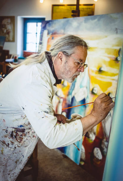 istock Artist painting in his studio 1157327395