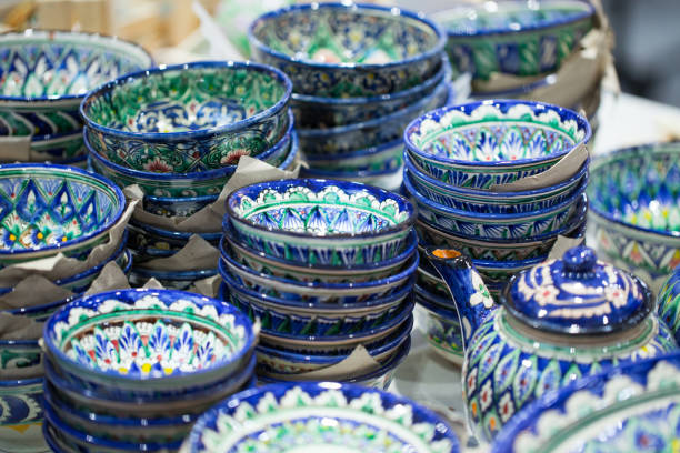 istock Bright oriental colored plates. Authentic dishes hand-painted in national style. Beautiful bowls and plates in the oriental bazaar. Bright background illustrating the national oriental style. 1157329544
