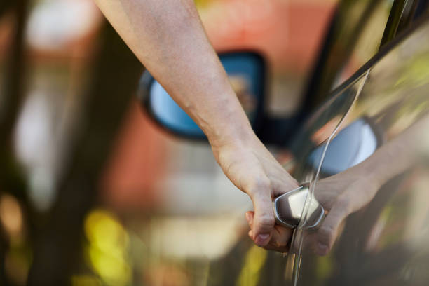istock A young guy opens the car door by the handle. 1157329630
