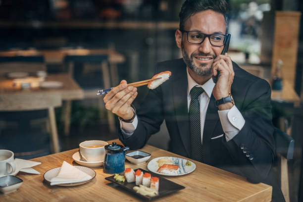 istock Businessman talking on phone on a lunch break 1157329762
