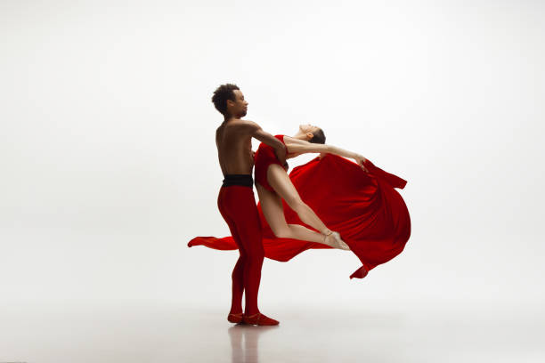 istock Young graceful couple of ballet dancers dancing on white studio background 1157332568