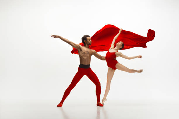istock Young graceful couple of ballet dancers dancing on white studio background 1157332569