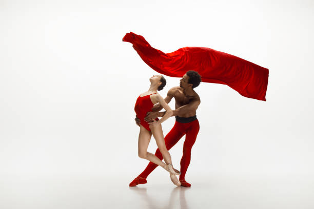 istock Young graceful couple of ballet dancers dancing on white studio background 1157332590