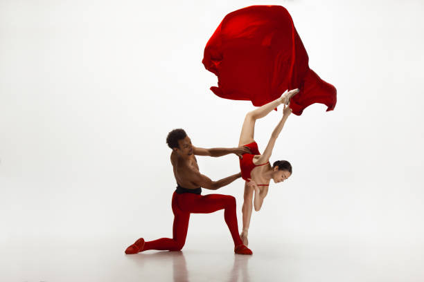 istock Young graceful couple of ballet dancers dancing on white studio background 1157332591