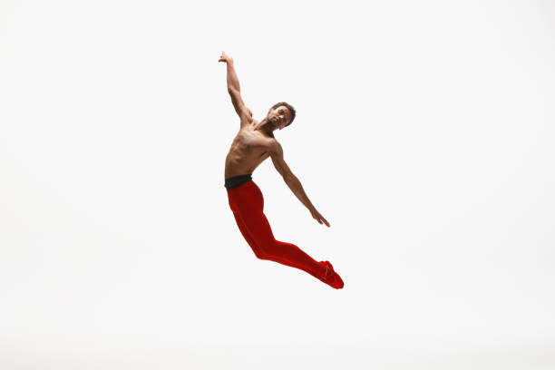istock Young graceful male ballet dancer dancing on white studio background 1157332607