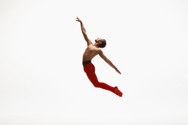 istock Young graceful male ballet dancer dancing on white studio background 1157332609