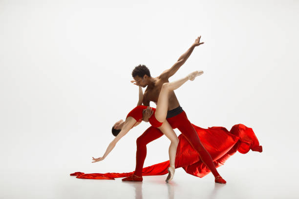 istock Young graceful couple of ballet dancers dancing on white studio background 1157332610