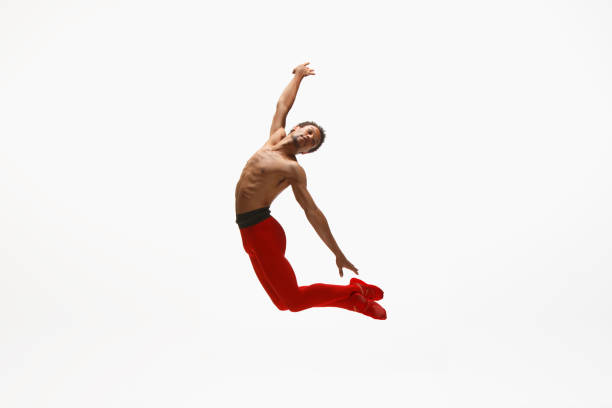 istock Young graceful male ballet dancer dancing on white studio background 1157332611