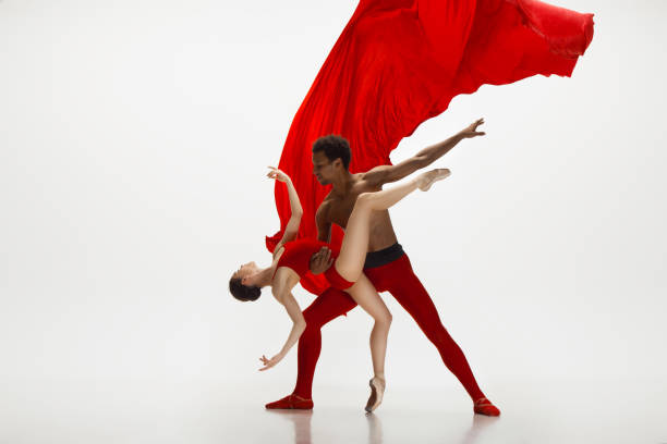 istock Young graceful couple of ballet dancers dancing on white studio background 1157332616