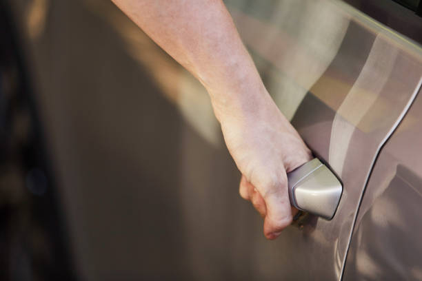 istock A young guy opens the car door by the handle. 1157332719