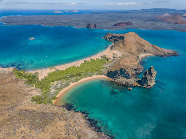 Aerial view of Pinnacle Rock, Bartolome Island, Galapagos, Ecuador Aerial view of the famous Pinnacle Rock on the small island of Bartolome, Galapagos, Ecuador. In the background is Santiago island. isla san salvador stock pictures, royalty-free photos & images