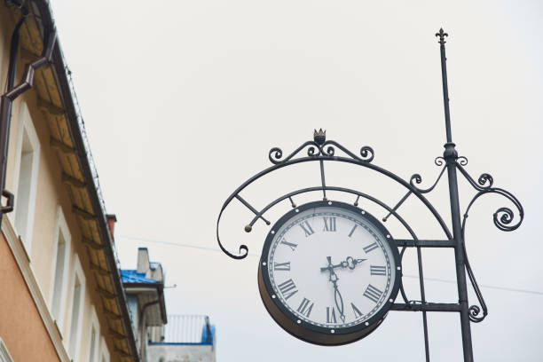 istock Old medieval clock on a city street. 1157335422