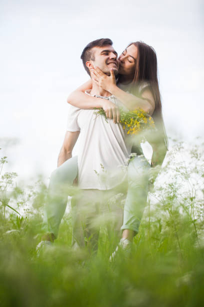 istock couple among wildflowers hugging 1157341305