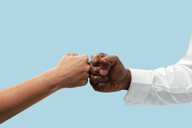 istock Two male hands competion in arm wrestling isolated on blue studio background 1157341904
