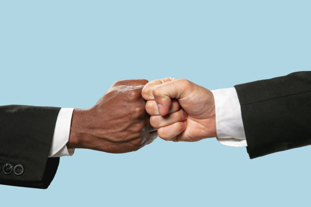 istock Two male hands competion in arm wrestling isolated on blue studio background 1157341939