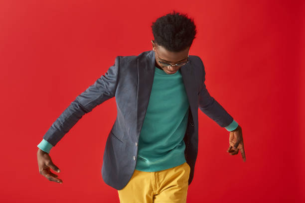 istock Stylish young man in glasses is making dance moves 1157343623
