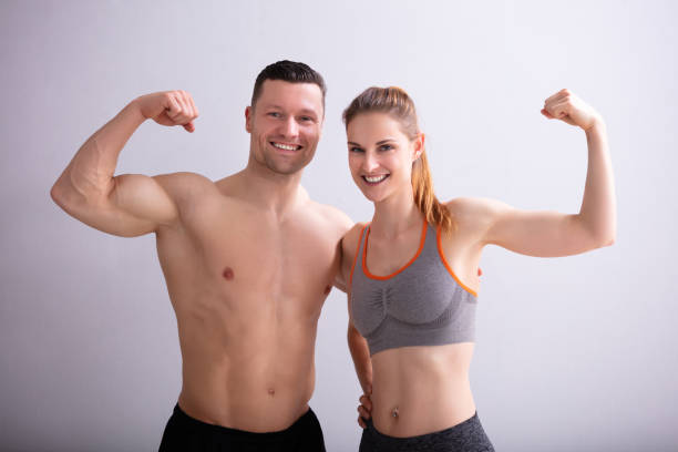 istock Couple Showing Muscles 1157345105