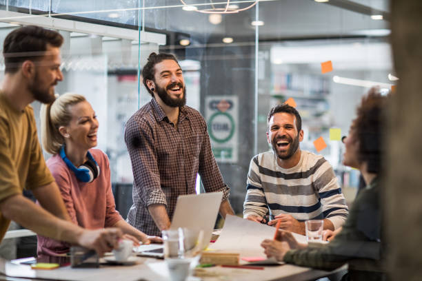 istock Cheerful creative people communicating while having a meeting at casual office. 1157345352