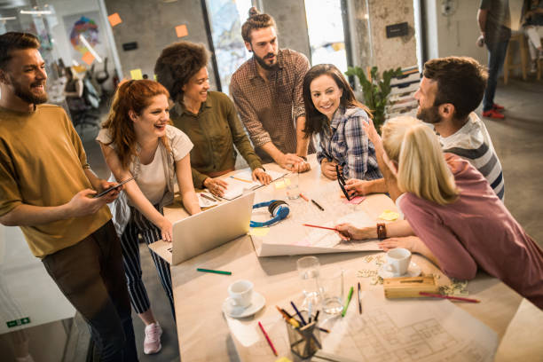 istock Young happy architects talking about blueprints on a meeting in the office. 1157345476