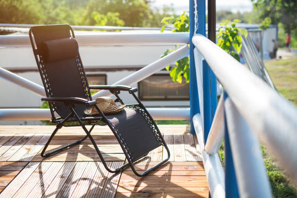 Chair on porch and sun hat on sunrise.