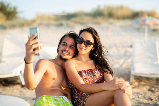 istock Young couple making a selfie on the beach. 1157351789