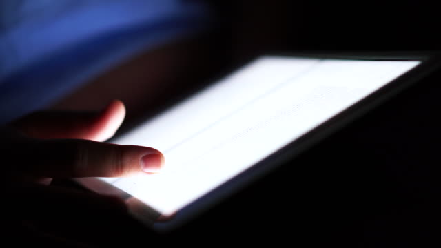 Using tablet in the dark room.