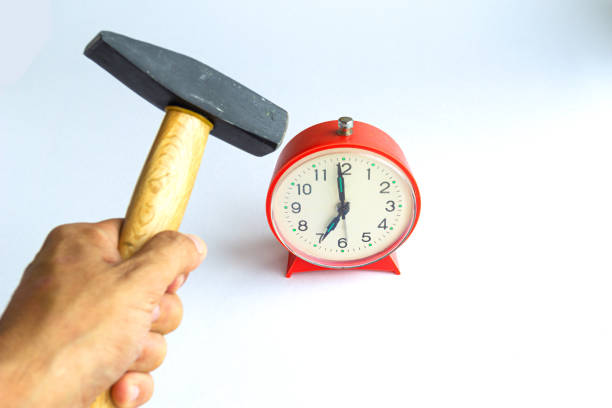 istock Hammer Hitting Alarm clock , isolated on white 1157352388