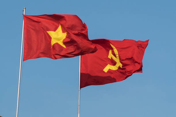 istock Vietnamese and communist flags in the wind 1157352417