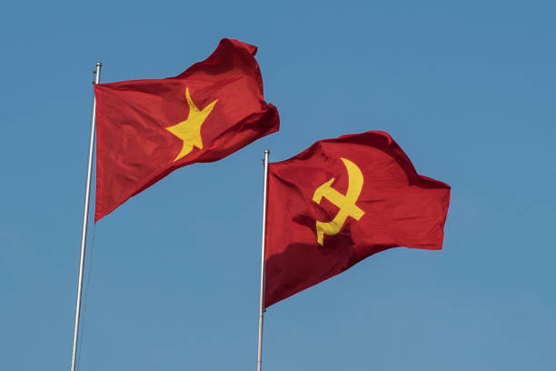 istock Vietnamese and communist flags in the wind 1157352696