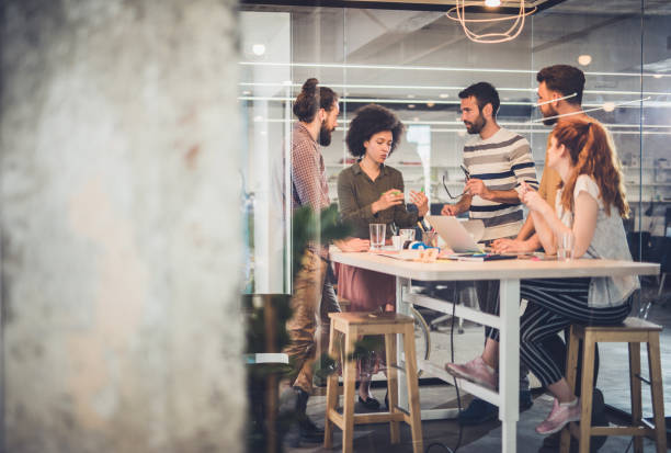 istock Team of creative people talking at casual office. 1157352830