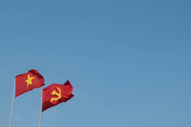 istock Vietnamese and communist flags in the wind 1157353509