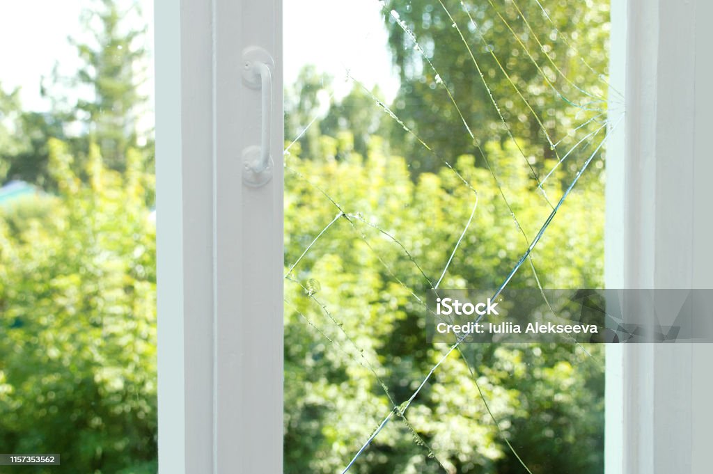 Broken glass on a wooden window frame. Window Stock Photo