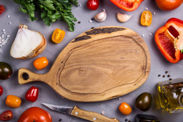 istock Ripe tomatoes for cooking vegetable dish on a gray background 1157353594