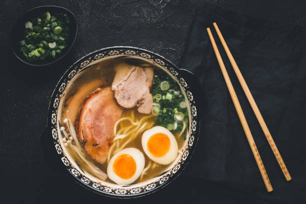 istock Ramen Soup with Noodles, Pork and Eggs on Dark Background 1157353679