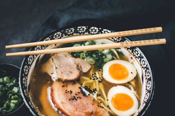istock Ramen Soup with Noodles, Pork and Eggs on Dark Background 1157353681