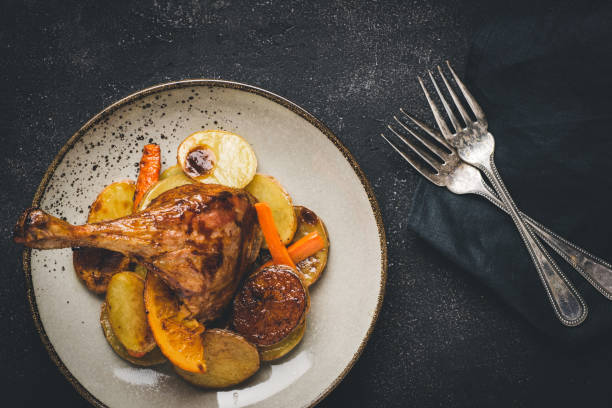 istock Roasted Goose Leg with Potatoes, Carrots and Oranges 1157354951