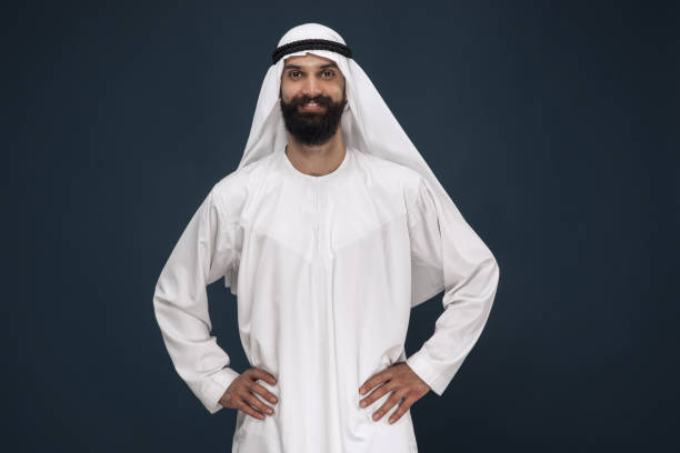 istock Arabian saudi businessman on dark blue studio background 1157355279