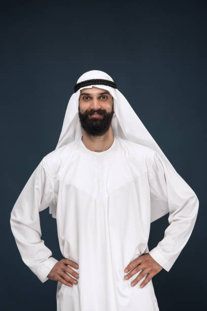 istock Arabian saudi businessman on dark blue studio background 1157355289