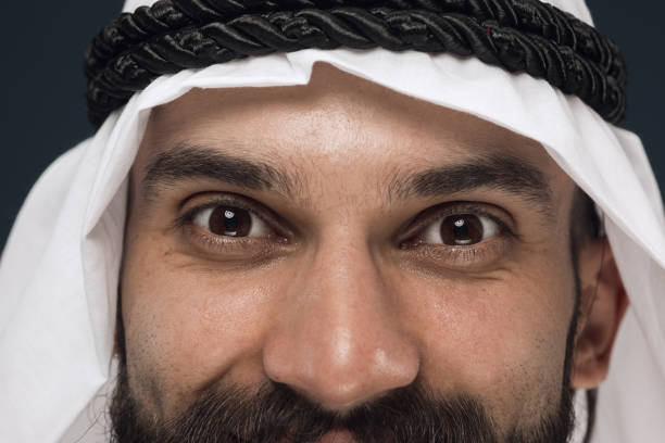 istock Arabian saudi man on dark blue studio background 1157355365