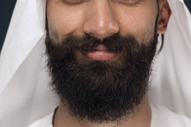 istock Arabian saudi man on dark blue studio background 1157355370