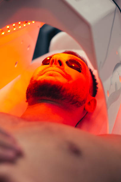 istock Bearded man in solarium looking glad and smiling 1157357205