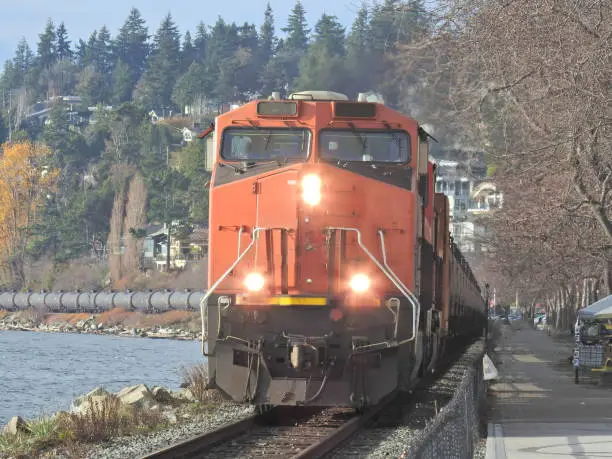 Front view of an oil tanker pulling a large consignment of wagons