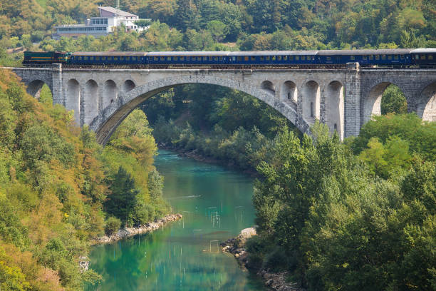 istock Obsolete diesel train crosing Soca River on Solkan Stone Bridge 1157360989