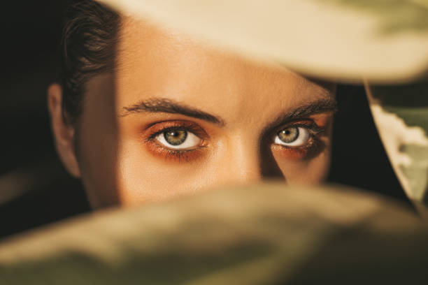 istock Beautiful woman behind leaves 1157362415