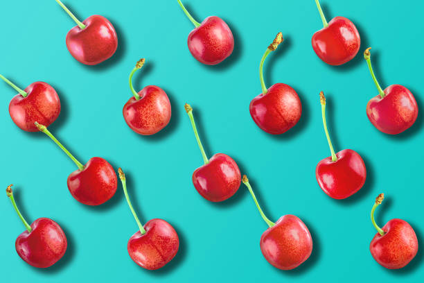 istock Cherry pattern. Flat lay of cherries on a blue background 1157364267