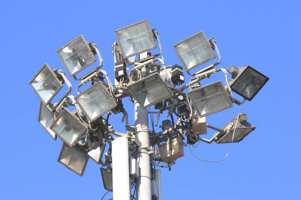 istock High-altitude floodlight with several powerful lighting lanterns against sky 1157364318