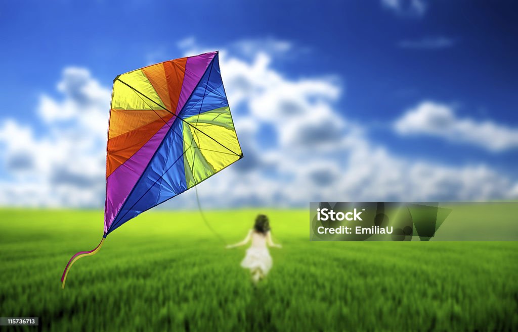 Kite Girl flying a kite in a meadow Kite - Toy Stock Photo