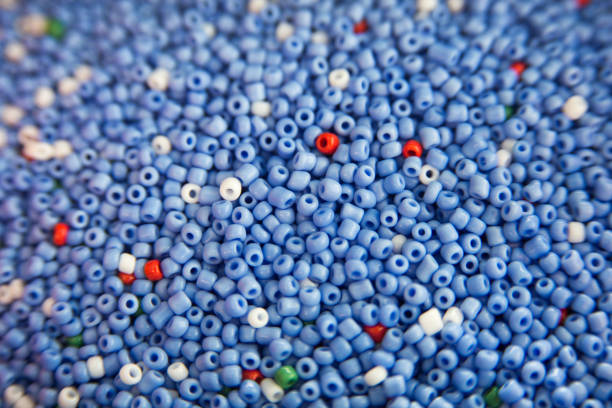 beaucoup de perles en plastique fusibles colorées utilisées pour les arts et l'artisanat. décoration pour le papier peint de bureau, affiche, livret de couverture, carte. - bead bugle necklace red photos et images de collection