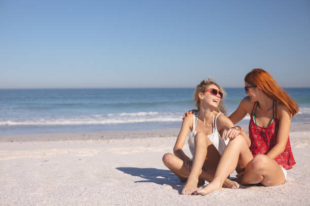 istock Female friends having fun together on the beach 1157374110