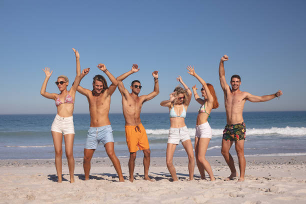 istock Group of friends dancing together on the beach 1157374788